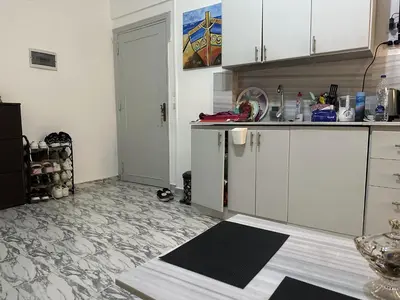 a kitchen with white cabinets and a counter top at Angie House Embassy area with wi fi in Hurghada