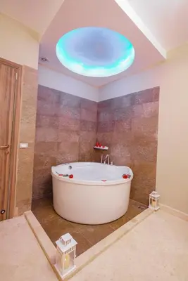 a bath tub in a bathroom with a round ceiling at El Gouna South Marina 1 Bedroom Apartement with private Jacuzzi in Hurghada