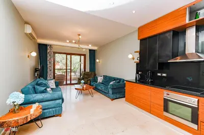 a living room with two blue couches and a tv at El Gouna South Marina 1 Bedroom Apartement with private Jacuzzi in Hurghada