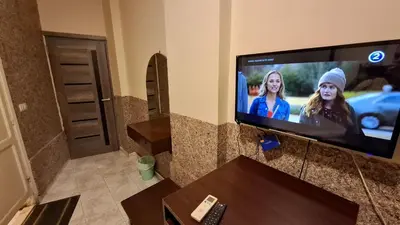 a flat screen tv sitting in a living room at Canary Hotel in Hurghada