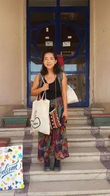 a woman standing on the stairs holding bags at Canary Hotel in Hurghada