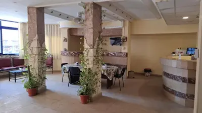 a dining room with a table with plants on it at Canary Hotel in Hurghada