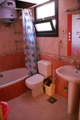a bathroom with a toilet and a sink at Esplanada Beach Apartment, no single men in Hurghada