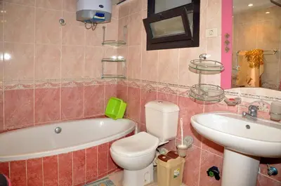 a bathroom with a tub and a toilet and a sink at Esplanada Beach Apartment, no single men in Hurghada