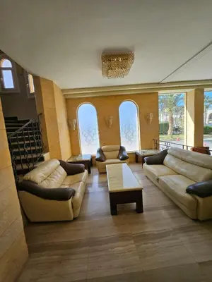 a living room with couches and tables and windows at Palm Beach Piazza Apart hotel Sahl Hasheesh in Hurghada