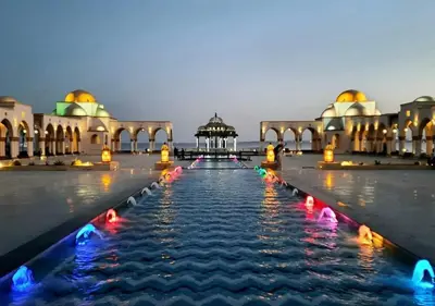a fountain in front of a building with a gazebo at Palm Beach Piazza Apart hotel Sahl Hasheesh in Hurghada