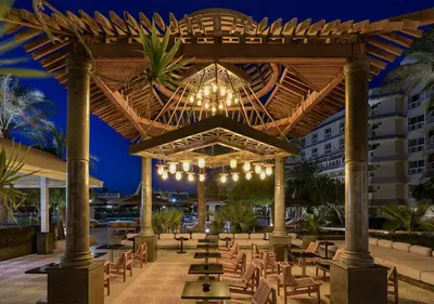 a pavilion with tables and chairs and a building at Sindbad Club in Hurghada