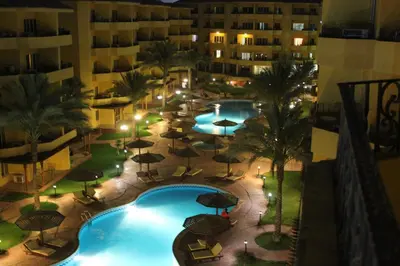 an aerial view of a hotel pool with umbrellas at Pool View Apartment at British Resort - Unit 02 in Hurghada