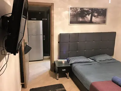 a living room with a bed and a television at Pool View Apartments at British Resort - Unit 13 in Hurghada