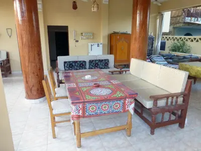 a dining room with a table and chairs at Terrasses et Jardins sur le Nil chez Hagag rive Ouest in Luxor