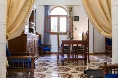 a room with a table and chairs and a window at Terrasses et Jardins sur le Nil chez Hagag rive Ouest in Luxor