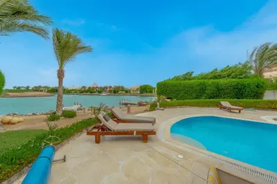a swimming pool with a chaise lounges and a swimming pool at Stunning Villa for Rent in El Gouna HEATED PRIVATE POOL in Hurghada