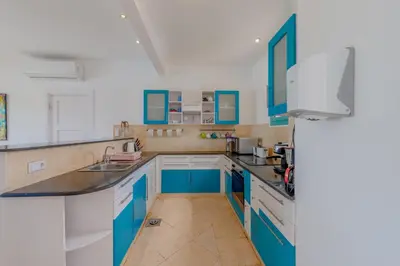 a blue and white kitchen with blue cabinets at Stunning Villa for Rent in El Gouna HEATED PRIVATE POOL in Hurghada