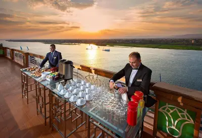 two men standing at a table with wine glasses at Sonesta St. George Hotel - Convention Center in Luxor