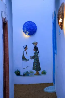 a painting of two people shaking hands on a wall at Nubian Palace Eco Lodge - A Nubian Home Since 1959 in Aswan