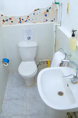 a bathroom with a white toilet and a sink at Nubian Palace Eco Lodge - A Nubian Home Since 1959 in Aswan