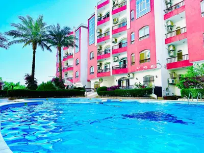 a large swimming pool in front of a building at Desert Pearl Apartment in Hurghada
