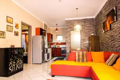 a living room with a couch and a kitchen at Desert Pearl Apartment in Hurghada