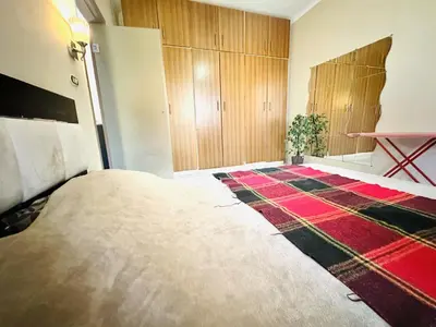 a bedroom with a large bed and a rug at Desert Pearl Apartment in Hurghada