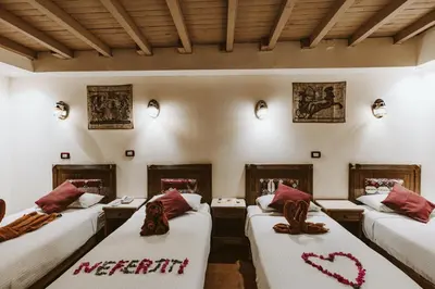 a room with four beds with a heart on them at Nefertiti Hotel Luxor in Luxor