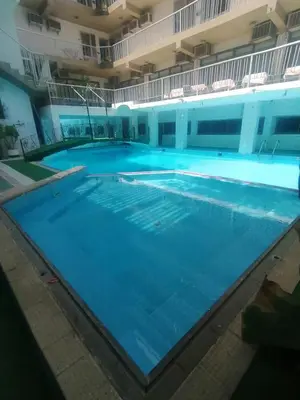 a large swimming pool in a large building at Windsor Hotel Luxor \u60a8\u5728\u76e7\u514b\u7d22\u7684\u7b2c\u4e8c\u500b\u5bb6 in Luxor