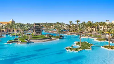an aerial view of a resort with palm trees and blue water at Pickalbatros The Palace Port Ghalib in Port Ghalib