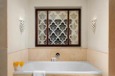 a bathroom with a bath tub with a window at Pickalbatros The Palace Port Ghalib in Port Ghalib