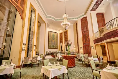 a restaurant with tables and chairs and a chandelier at Pickalbatros The Palace Port Ghalib in Port Ghalib