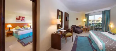 a hotel room with two beds and a living room at Amwaj Beach Club Abu Soma in Hurghada