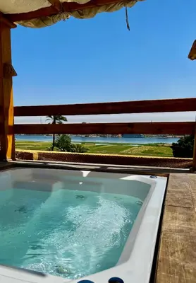 a bath tub with a view of the ocean at Jewel Howard Carter Hotel in Luxor