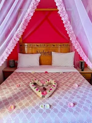 a bed with a heart made out of flowers at Jewel Howard Carter Hotel in Luxor