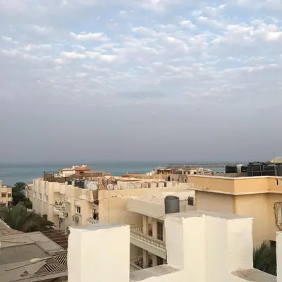 a view of a city with white buildings and the ocean at Villamar Sea View rooms & apartments in Hurghada