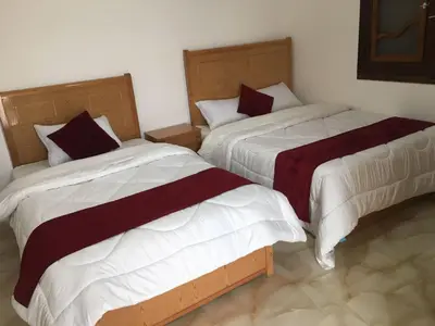 two beds sitting next to each other in a room at Villamar Sea View rooms & apartments in Hurghada