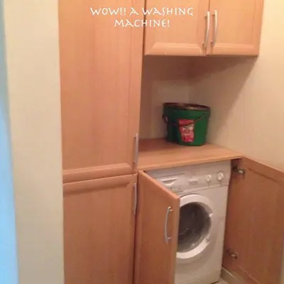 a laundry room with a washing machine and a washer at Apartment at Palm Beach Piazza in Hurghada