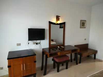 a bathroom with a vanity and a mirror and a desk at Sharm El Naga Resort and Diving Center in Hurghada