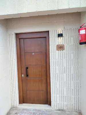a building with a wooden door in front of it at Sharm El Naga Resort and Diving Center in Hurghada