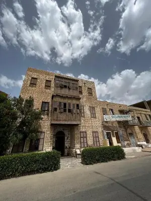 an old brick building on the side of a street at El Quseir Hotel in Quseir