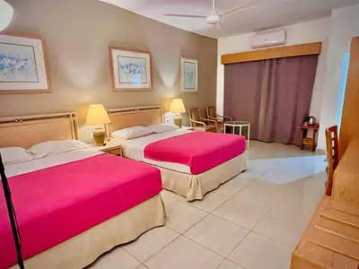 a hotel room with two beds with pink sheets at Masaya Hurghada in Hurghada