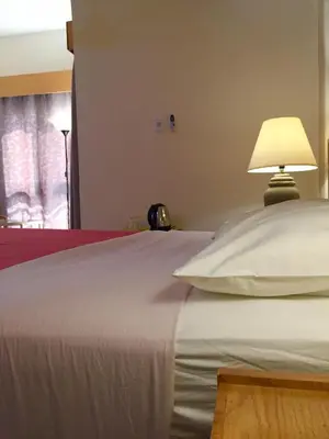 a white bed with a lamp on top of it at Masaya Hurghada in Hurghada