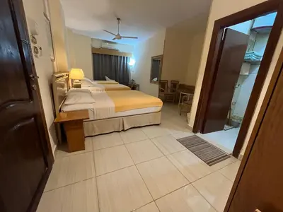 a hotel room with a bed and a room entrance at Masaya Hurghada in Hurghada