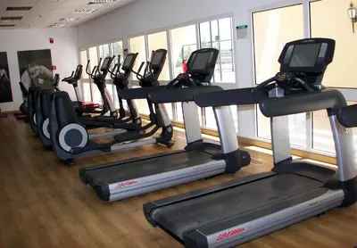 a row of tread machines in a gym at Hurghada Suites & Apartments Serviced by Marriott in Hurghada