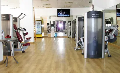 a gym with several treadmills and machines at Hurghada Suites & Apartments Serviced by Marriott in Hurghada