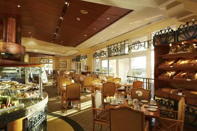 a dining room with tables and chairs in a restaurant at Hurghada Suites & Apartments Serviced by Marriott in Hurghada
