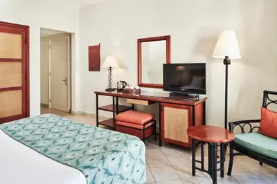 a hotel room with a television and a bed and a desk at Fanadir Hotel El Gouna in Hurghada