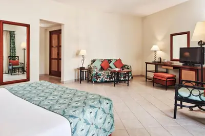 a hotel room with a bed and a living room at Fanadir Hotel El Gouna in Hurghada