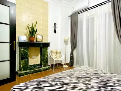 a bedroom with a bed and a fireplace at Zebra Apartments Hurghada center in Hurghada