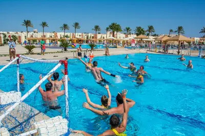 a group of people playing volleyball in a swimming pool at Sunrise Royal Makadi Resort in Hurghada