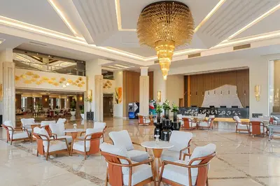 a lobby with tables and chairs and a chandelier at Beach Albatros Aqua Park - Hurghada in Hurghada