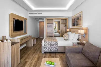 a hotel room with a bed and a couch at Beach Albatros Aqua Park - Hurghada in Hurghada