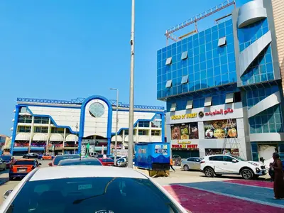 a street with cars parked in front of a building at Tamburine Chalet with Wi Fi Hurghada center in Hurghada